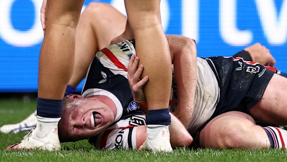 Drew Hutchison in pain after the hit from Dylan Brown. 