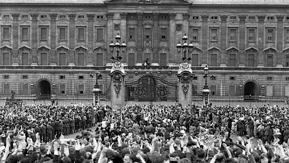 A vast crowd assembles in front of Buckingham Palace, London to cheer Britain's Royal family as they come out on the balcony, centre, minutes after the official announcement of Germany's unconditional surrender in World War II on May 8, 1945. 