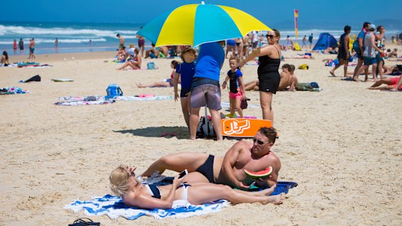 Swimmers and sunbakers bask in hot weather on the Gold Coast beaches.