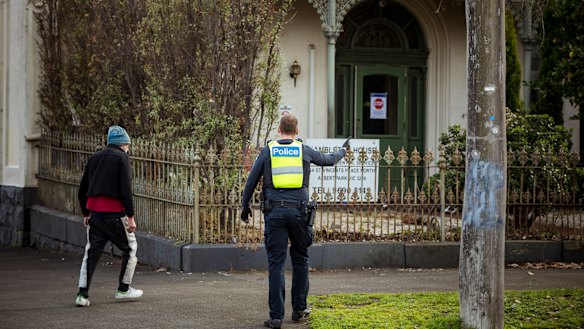 Police escort a resident of Hambleton House back to his residence after he left the property on Monday morning. Hambleton House is currently under lockdown after a COVID-19 outbreak. 