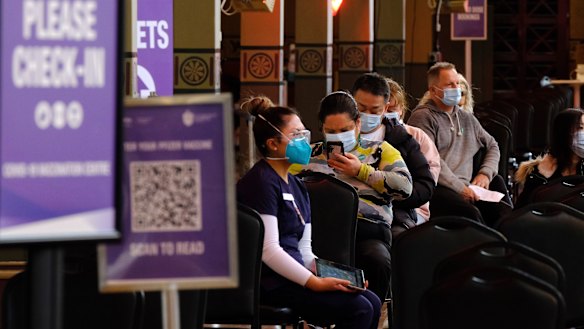 Patients wait for a COVID-19 jab at Melbourne’s Royal Exhibition Building. 