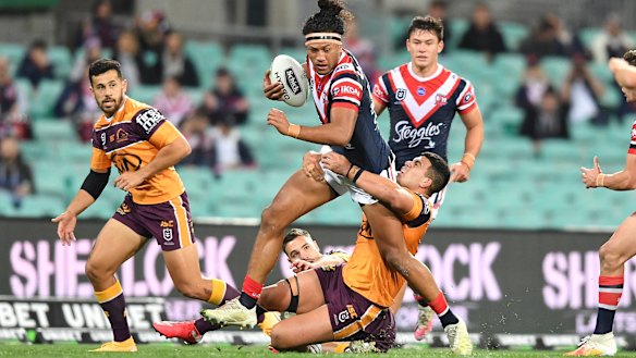 Sitili Tupouniua barges through the Brisbane defence.