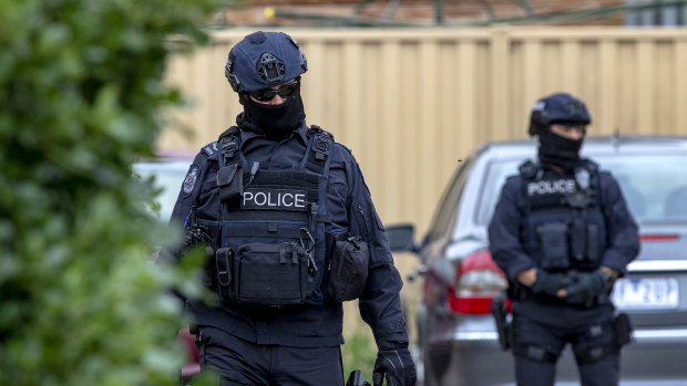 Police at the Dallas home of Ertunc Eriklioglu in Dallas, a northern suburb of Melbourne. 