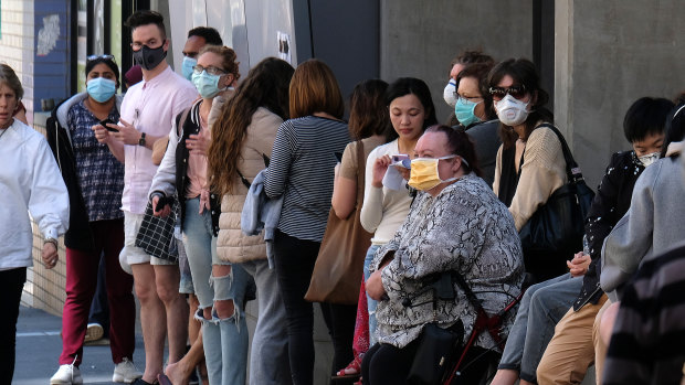 People wait outside the Royal Melbourne Hospital to be tested for coronavirus at a screening clinic on Tuesday.