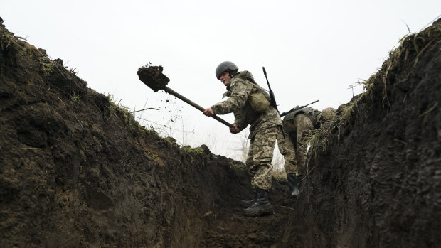 Ukrainian soldiers dig trenches at position near the front line with Russia-backed separatists in Shyrokyne, eastern Ukraine, on Wednesday.