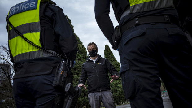 An anti-lockdown supporter is detained by Victoria Police.