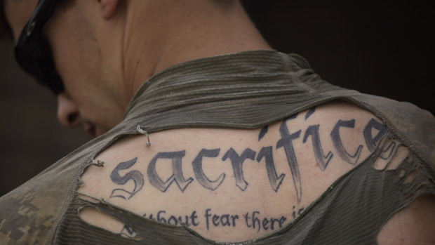 A tattoo on the back of US Army Sergeant James Wilkes seen through his torn shirt in Afghanistan’s Kandahar province in 2010. 