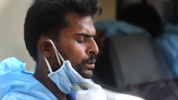 The strain of the pandemic is felt everywhere: An ambulance driver in Mumbai, India, takes a deep breath as he waits for hours outside a hospital to admit a COVID-19 patient.