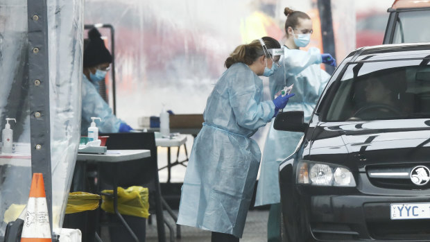 People queue up for COVID-19 testing at a pop-up site in Dandenong on Thursday.