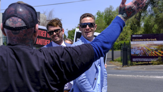 Protesters and racegoers interact before the Melbourne Cup.