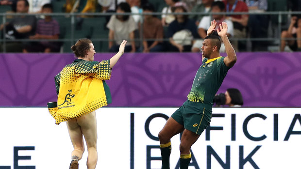 Wallabies star Kurtley Beale encounters a streaker in Oita during Australia's World Cup win over Uruguay. 