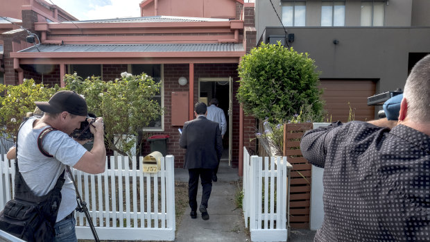 Detectives are seen at the Kensington house where a woman's body was found in a bathtub in Melbourne in January 2018.