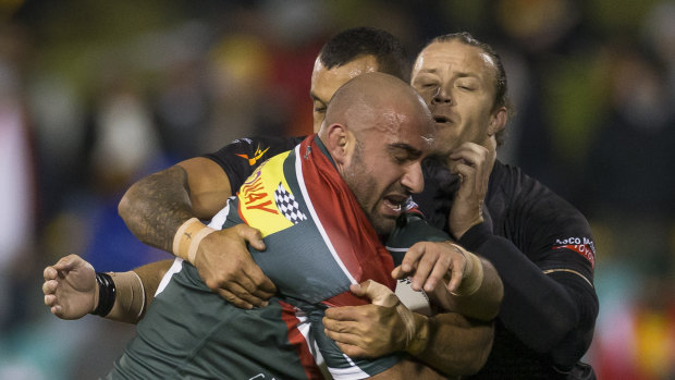 Going nowhere: Tim Mannah is wrapped up by the Fiji defence.