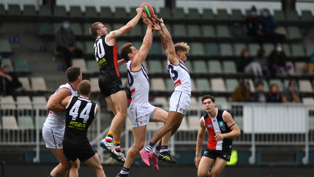 Liam Henry of the Dockers and Dougal Howard of the Saints compete for the ball.