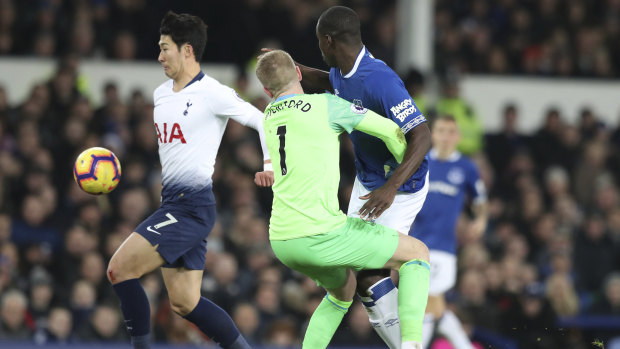 Everton goalkeeper Jordan Pickford collides with teammate Kurt Zouma, as Spurs' Son Heung-min scores.