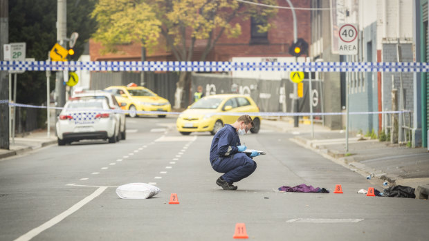 Forensic officers examine the scene of a shooting outside Love Machine nightclub in Prahran. 