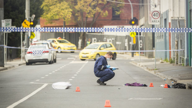 Forensic officers examine the scene of the shooting outside Love Machine nightclub in Prahran. 