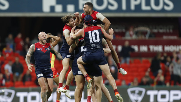 Demons players celebrate their win against Suns.