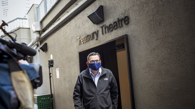 Daniel Andrews departs the daily COVID-19 press conference wearing a mask on Sunday.