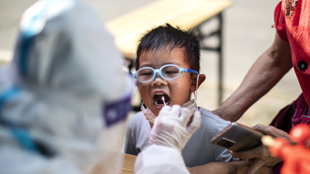 A medical worker takes samples during a mass COVID-19 test in a residential block in Wuhan, Hubei Province, China. 
