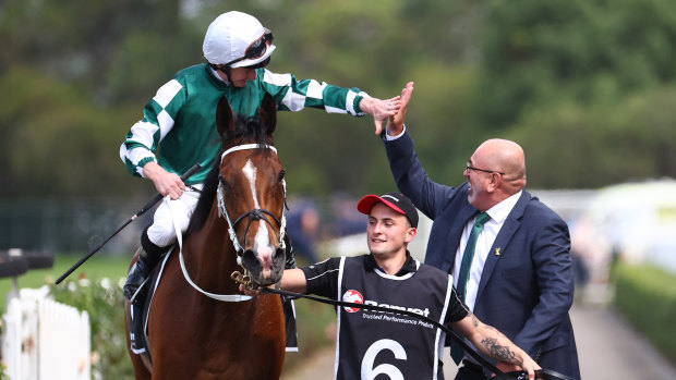 James McDonald high-fives Yulong’s Sam Fairgray as he returns on Via Sistina after winning the Ranvet Stakes.