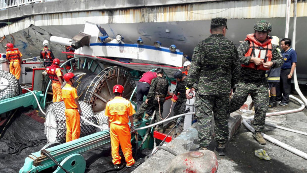 Rescuers work at the site of a collapsed bridge in Nanfangao, eastern Taiwan.