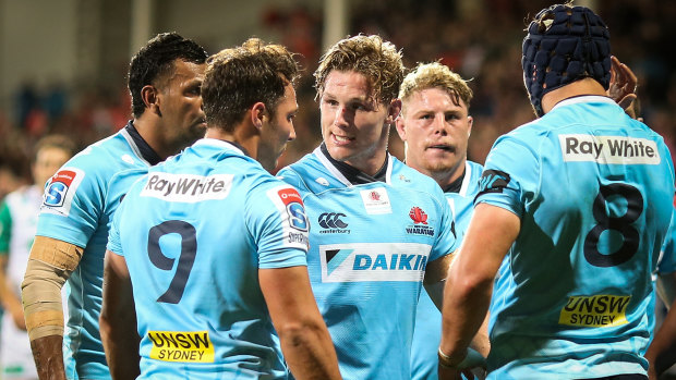 Dejected: Michael Hooper of the Waratahs (centre) speaks to his teammates. 