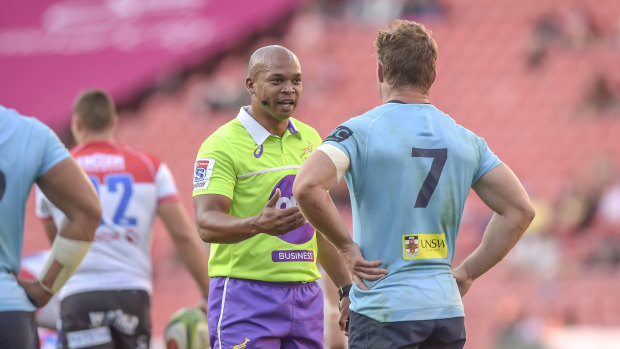 South African referee Egon Seconds speaks to Waratahs back-rower Michael Hooper. 