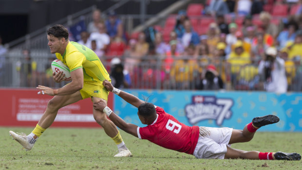 On-field action: Australia's men dominated Tonga to win 32-0 on Saturday.