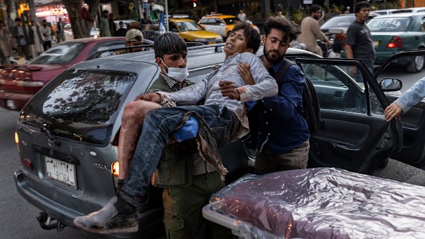 A person wounded in a bomb blast outside the Kabul airport in Afghanistan arrives at a hospital.