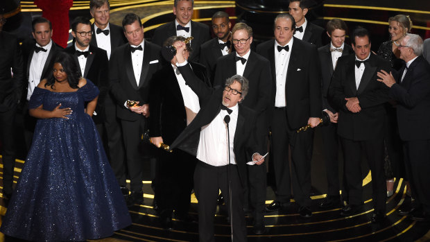 Peter Farrelly (centre) and the cast and crew of Green Book accept the award for best picture.