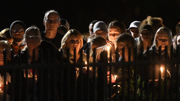 Family members and friends gather for a candlelight vigil memorial for the 20 people killed in Saturday's accident.