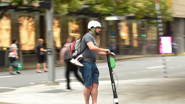 A Lime scooter user on the streets of Brisbane.
