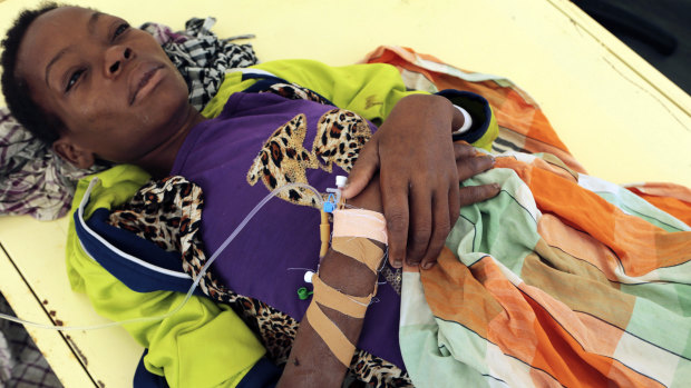 A woman diagnosed with cholera lies on a bed at a treatment centre in Beira, Mozambique, on Saturday, March 30.