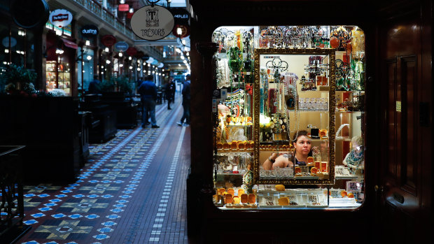 An employee attends to the window display of a jewellery store at a near-empty Strand Arcade in Sydney during a partial lockdown imposed due to the coronavirus.