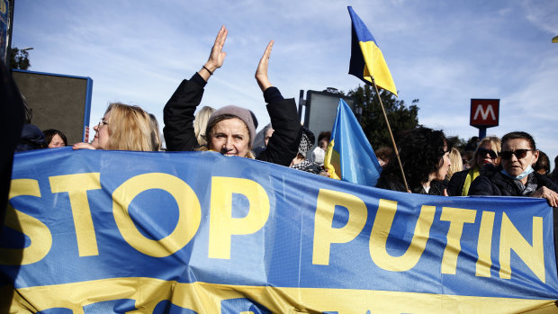 Demonstrators holding a banner with the Ukraine national colours in Rome.