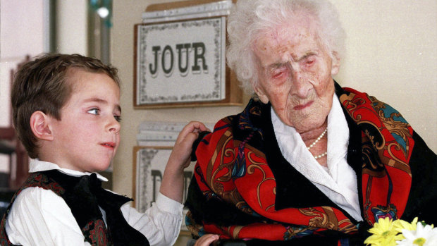 Jeanne Calment in a February 1997 file photo with five-year-old Thomas, who brought her flowers at her retirement home in Arles, France.