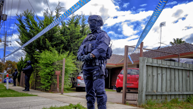 Police stand guard outside the house of Shire Ali's parents in Werribee on Saturday 10 November 2018.