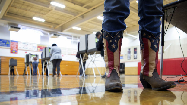 Chief election official Sandy Pace wears patriotic-themed boots while staffing the polling station at Drew Middle School on Election Day in Stafford, Virginia.