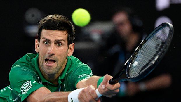 Serbia's Novak Djokovic makes a backhand return on his way to his Australian Open final victory over Austria's Dominic Thiem on February 2.