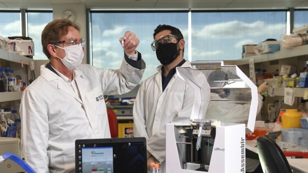 Professor of pharmaceutical biology Colin Pouton and bio-engineer Dr Harry Al-Wassiti with the new  trial COVID-19 vaccine at Monash Institute of Pharmaceutical Sciences. 