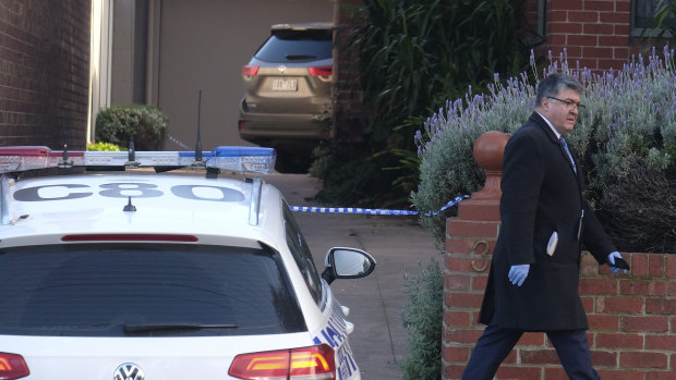 Police at the South Melbourne property where a woman's body was found.