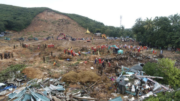 A rescue team works at a landslide-hit area in Paung township, in Myanmar, on Monday.