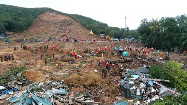 A rescue team works at a landslide-hit area in Paung township, in Myanmar, on Monday.