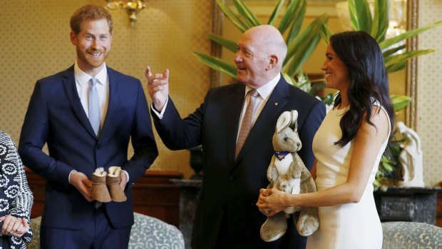 Prince Harry and Meghan Markle with their first baby gifts, from Governor-General Sir Peter Cosgrove.