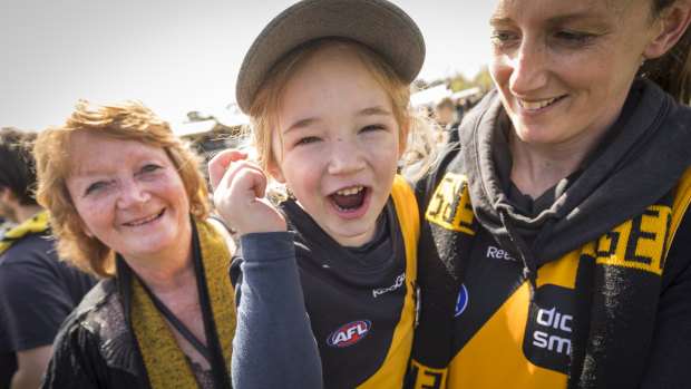 Kathy Bailey, Kellie Bailey-Lynn and Evie, lap up the atmosphere at Punt Road after Richmond's massive grand final win