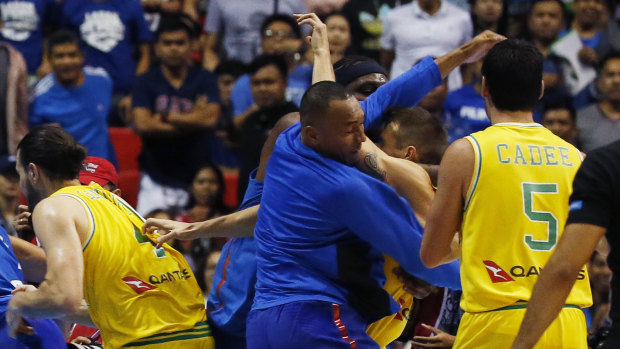 Australian and Philippines players brawl on court.