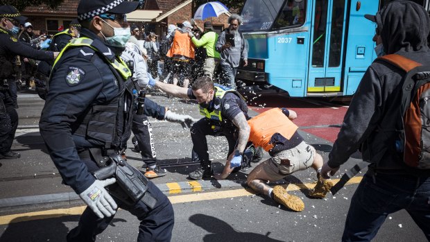 Protesters clashed with police during a violent anti-lockdown rally in Melbourne’s inner east on Saturday.