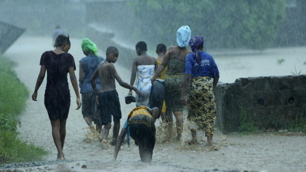People leave their flooded homes in the Natite neighbourhood of Pemba, on the north-eastern coast of Mozambique.