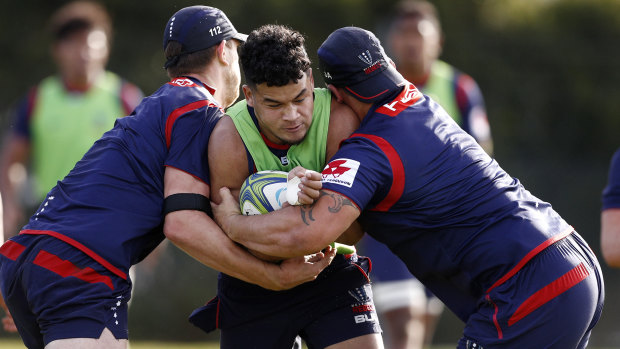 Stood down: Hunter Paisami (centre) is one of two Rebels players under investigation by the franchise over a weekend incident.